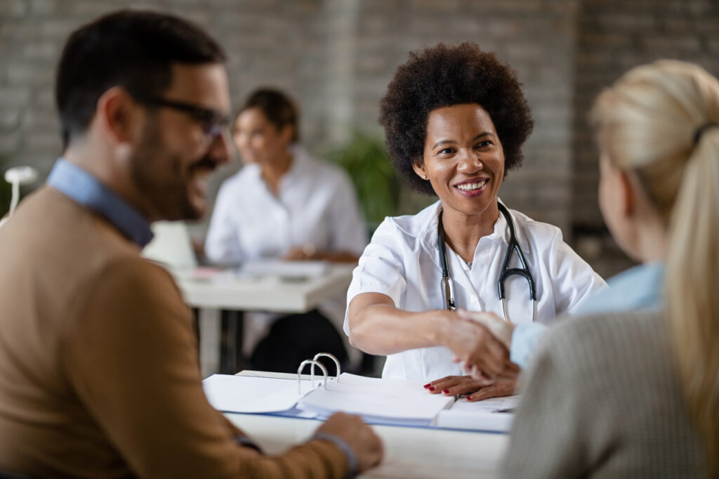 health insurance service nurse shaking hands with people